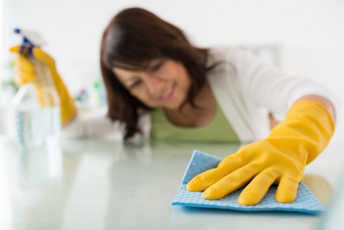 Technician wearing PPE during carpet cleaning in Westminster