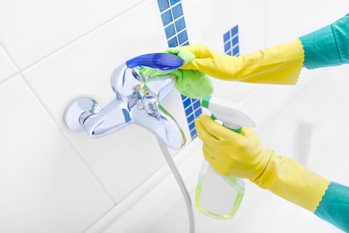 Domestic cleaner in Westminster tidying a stylish apartment kitchen